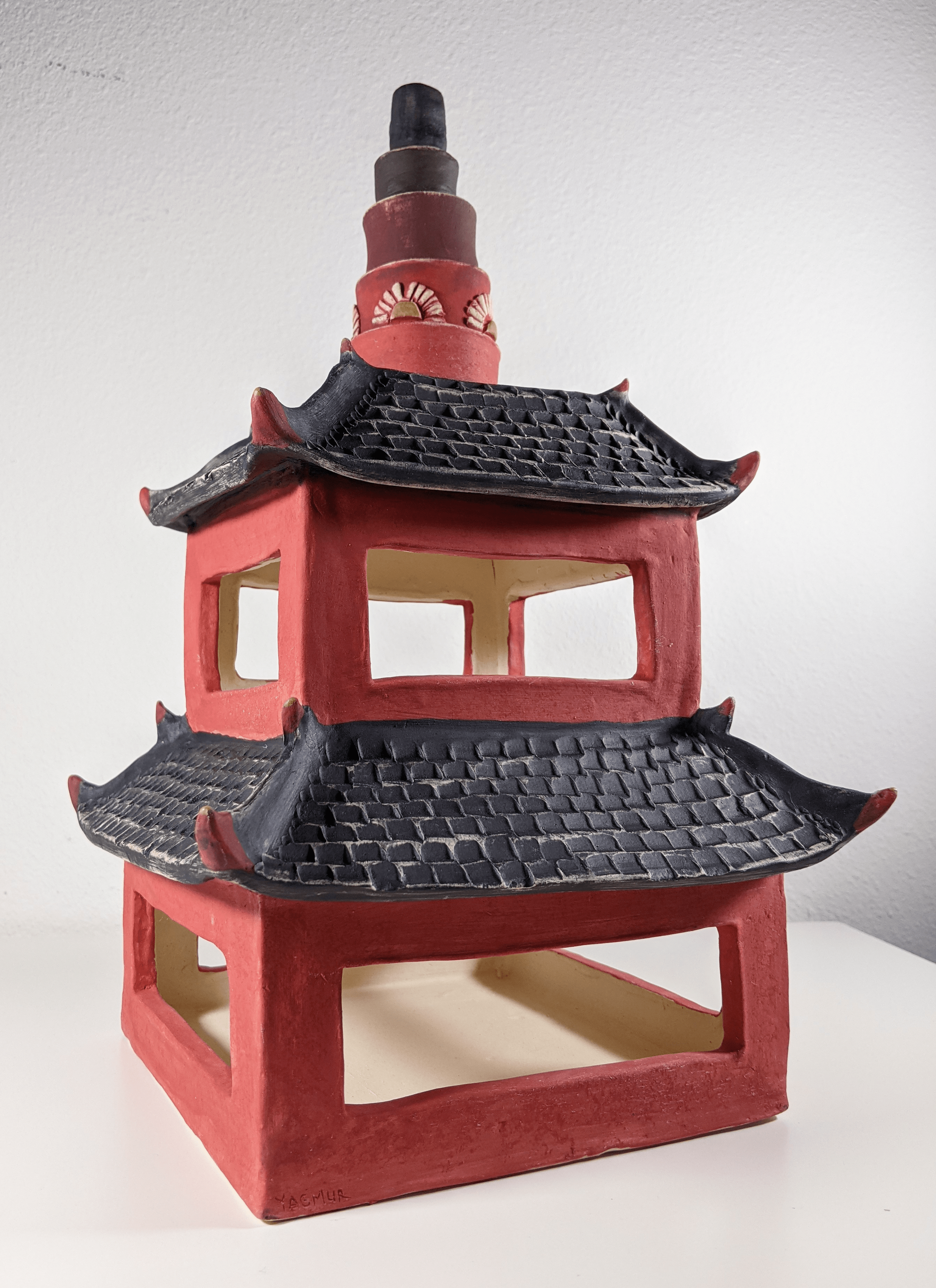 A red and black pagoda with two stores