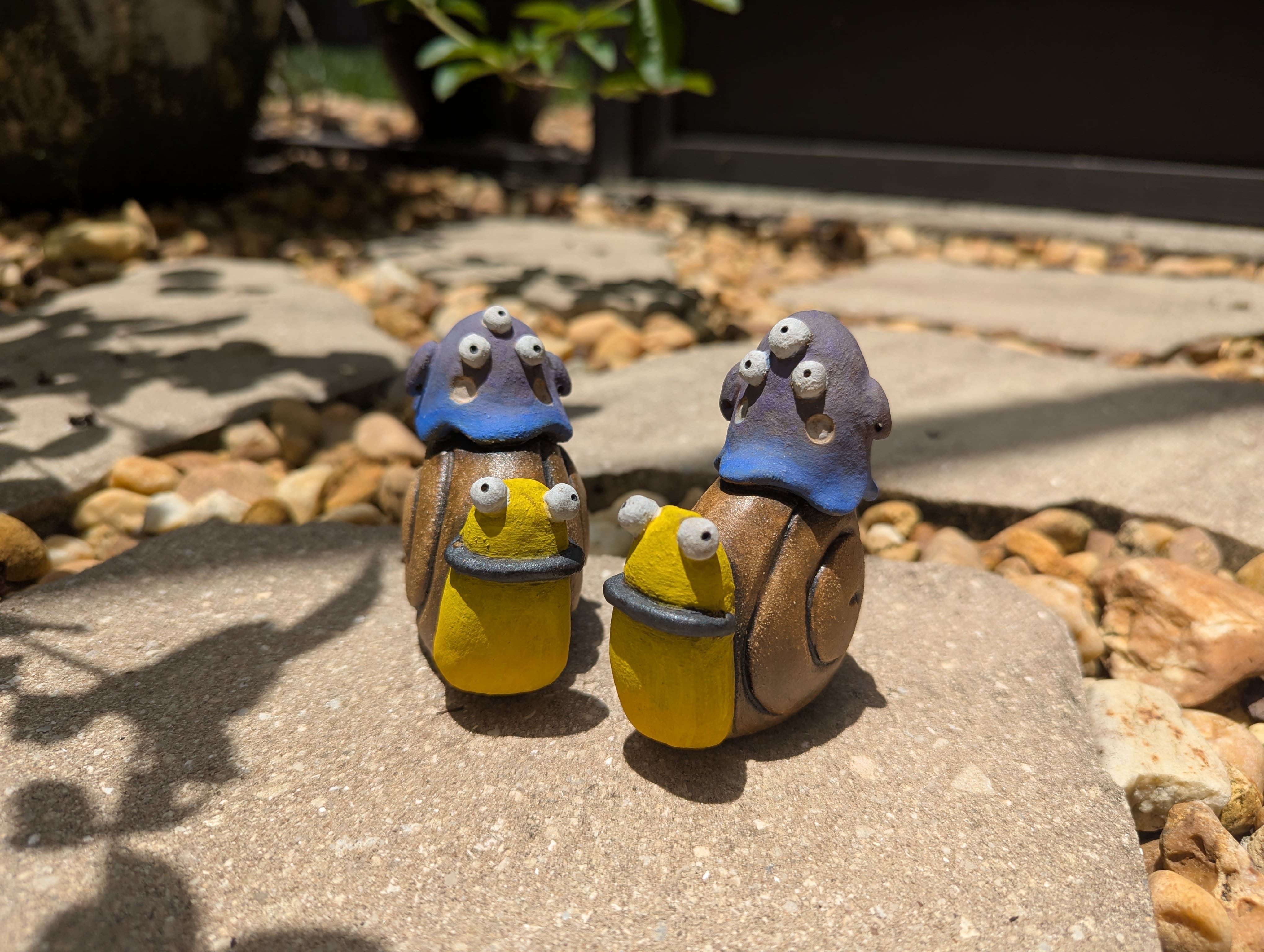 Monster statues riding slugs made from clay