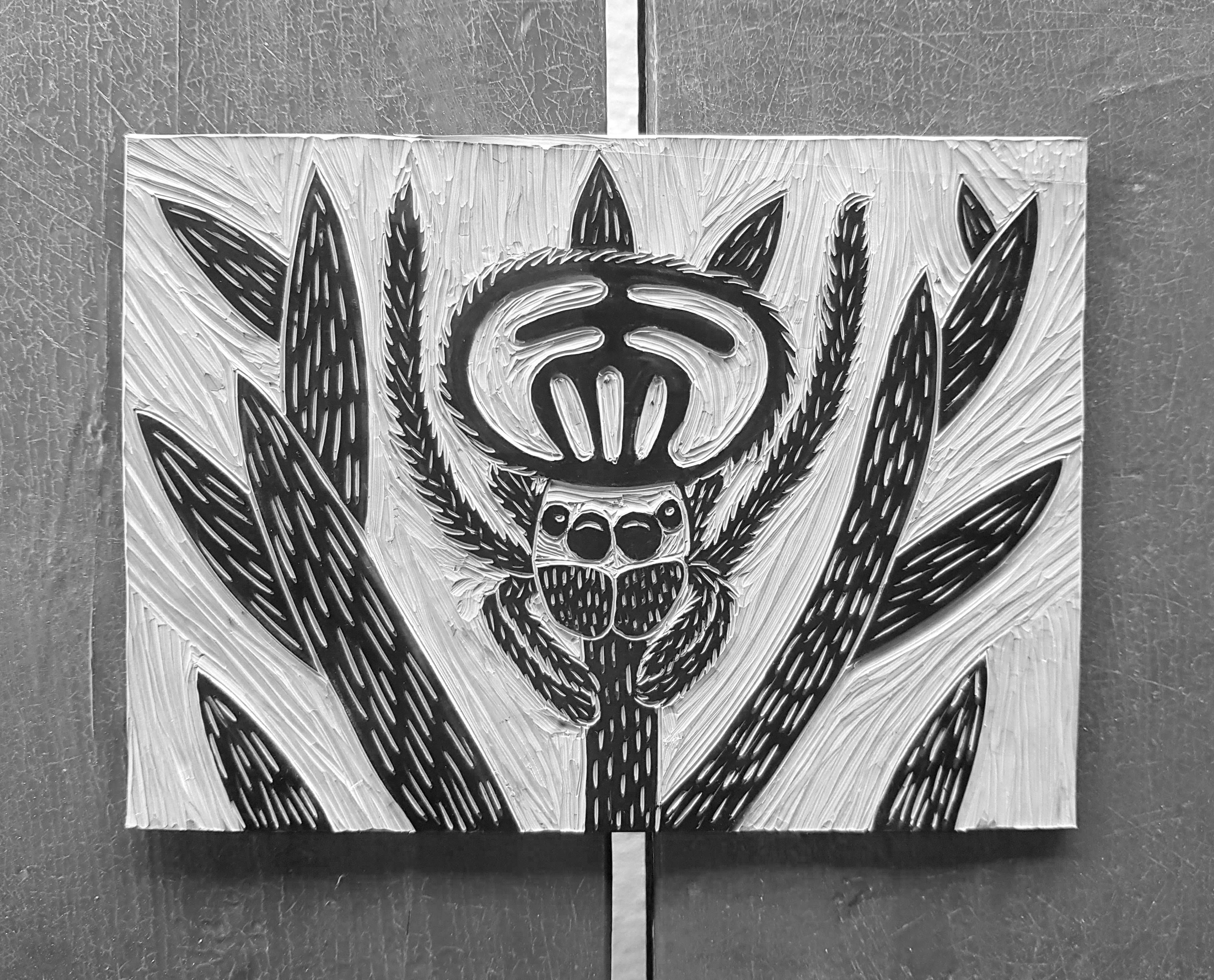 The linocut block of a jumping spider