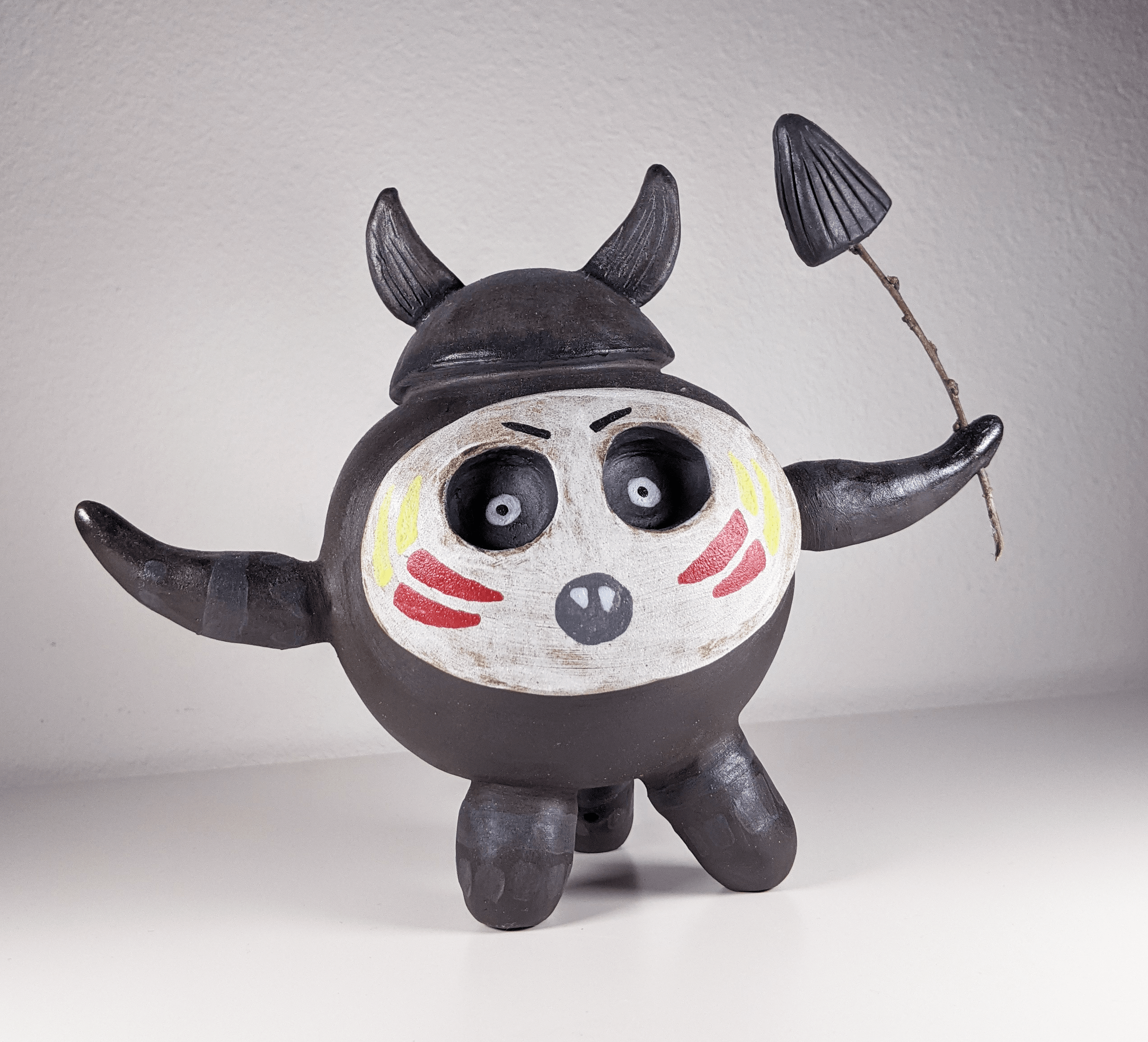 Small sculpture of a tiny tribal warrior creature